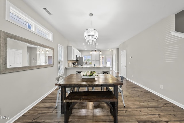 1625 Main Divide Dr, Wake Forest, NC 27587 - dining space with a chandelier, dark wood-type flooring, and plenty of natural light