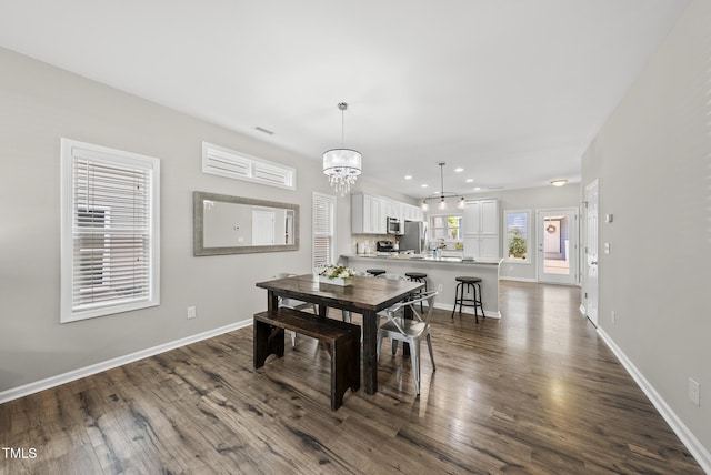 1625 Main Divide Dr, Wake Forest, NC 27587 - dining area with dark wood-style flooring, recessed lighting, and a chandelier