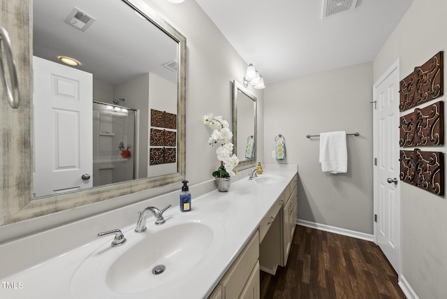 1625 Main Divide Dr, Wake Forest, NC 27587 - bathroom featuring double vanity, wood finished floors, and an enclosed shower