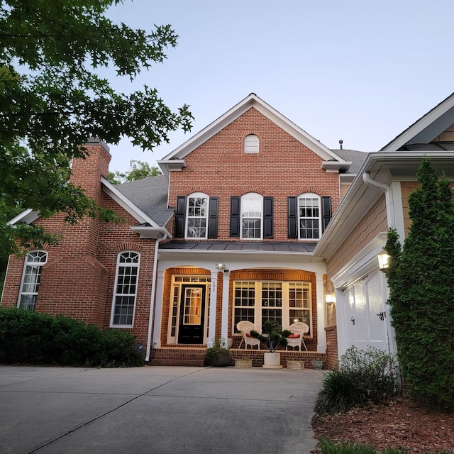 502 Willowmere Ct, Cary, NC 27513 - view of front of house with covered porch, brick siding, and a chimney