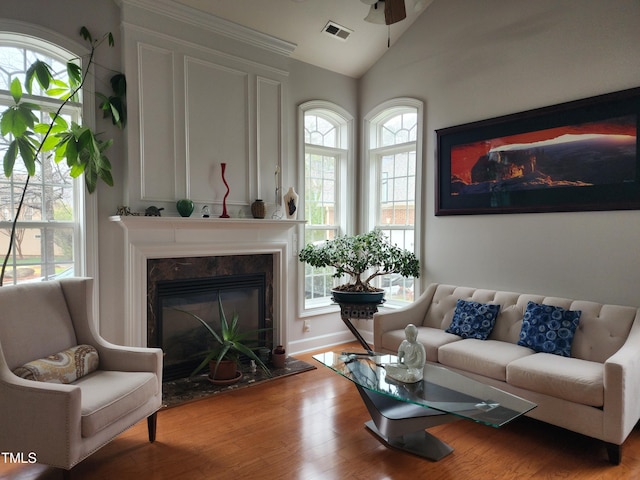 502 Willowmere Ct, Cary, NC 27513 - living room with lofted ceiling, wood finished floors, a fireplace, and a ceiling fan