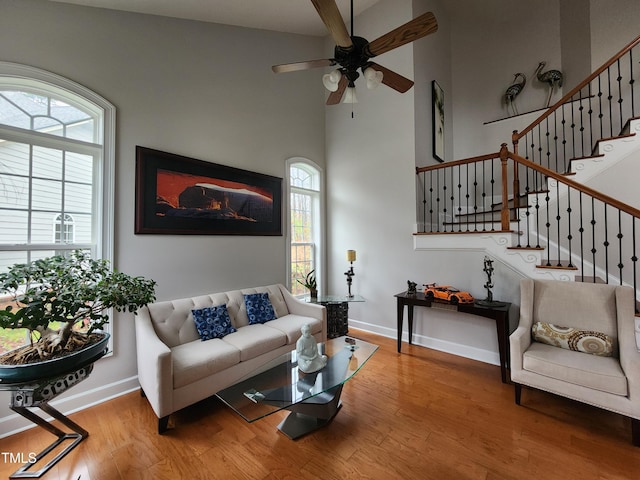 502 Willowmere Ct, Cary, NC 27513 - living room featuring wood finished floors, ceiling fan, healthy amount of natural light, and a high ceiling