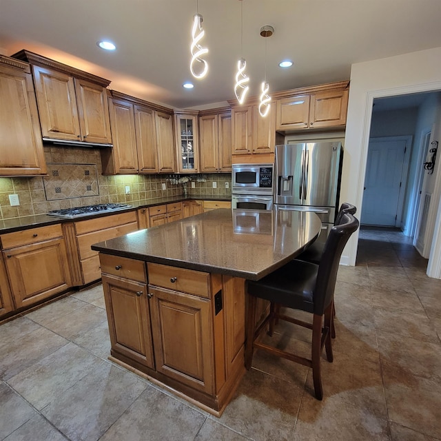 502 Willowmere Ct, Cary, NC 27513 - kitchen featuring stainless steel appliances, backsplash, a center island, brown cabinetry, and recessed lighting
