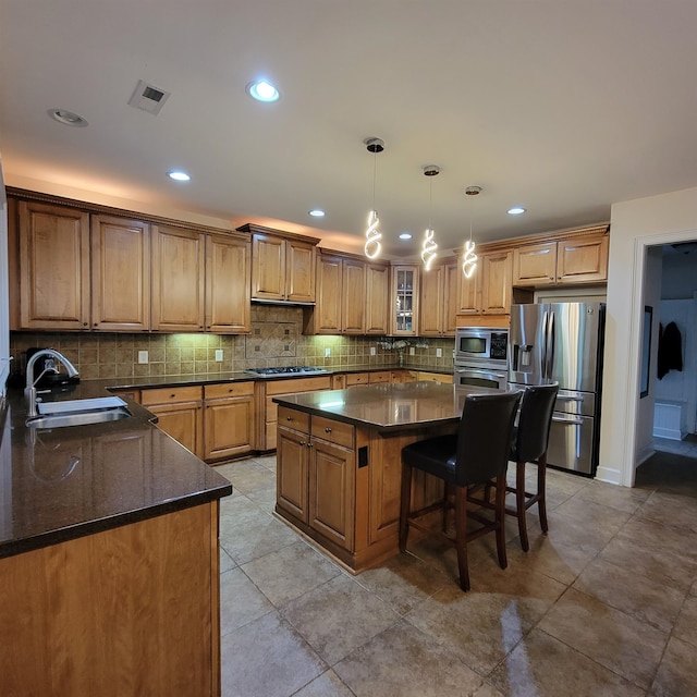 502 Willowmere Ct, Cary, NC 27513 - kitchen with stainless steel appliances, tasteful backsplash, a center island, brown cabinets, and a breakfast bar