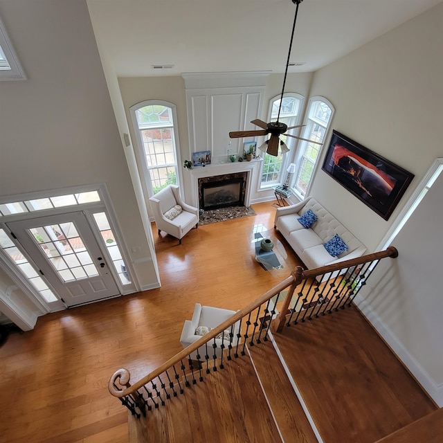 502 Willowmere Ct, Cary, NC 27513 - staircase with wood finished floors, a premium fireplace, and a ceiling fan