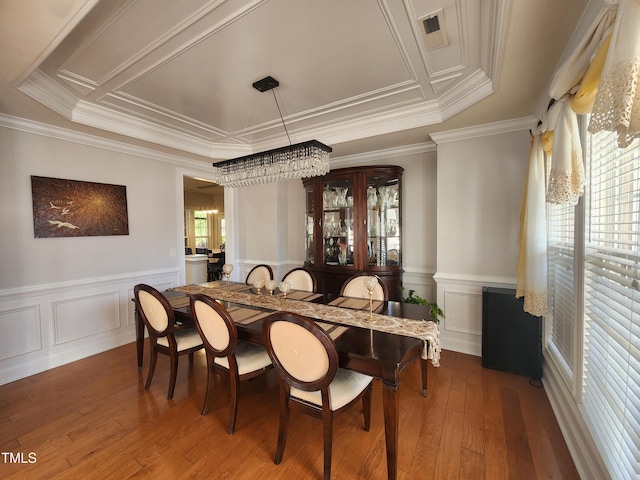 502 Willowmere Ct, Cary, NC 27513 - dining space featuring hardwood / wood-style floors, ornamental molding, a wainscoted wall, and a decorative wall
