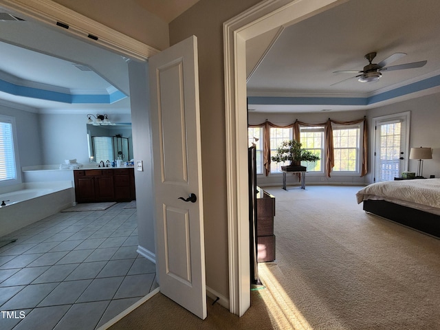 502 Willowmere Ct, Cary, NC 27513 - bedroom featuring ornamental molding, multiple windows, a tray ceiling, and light carpet