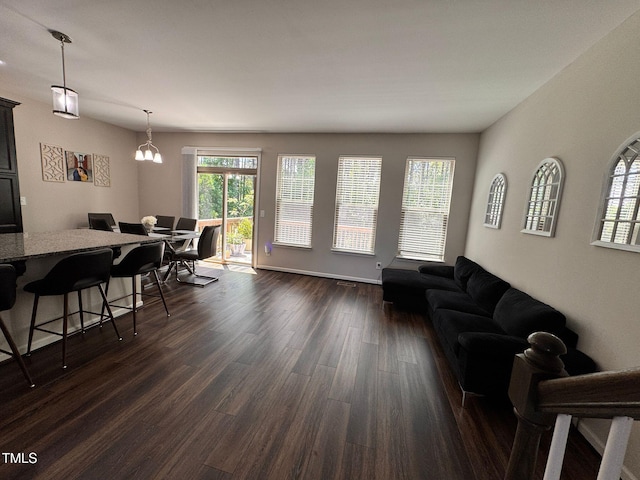 1005 Lathrop Ln, Apex, NC 27523 - living room with dark wood-style floors, plenty of natural light, and a chandelier