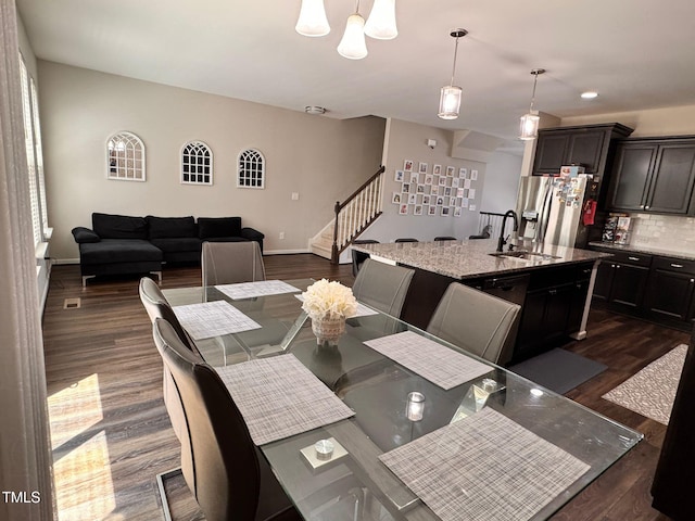 1005 Lathrop Ln, Apex, NC 27523 - dining room featuring stairway, dark wood finished floors, and a chandelier