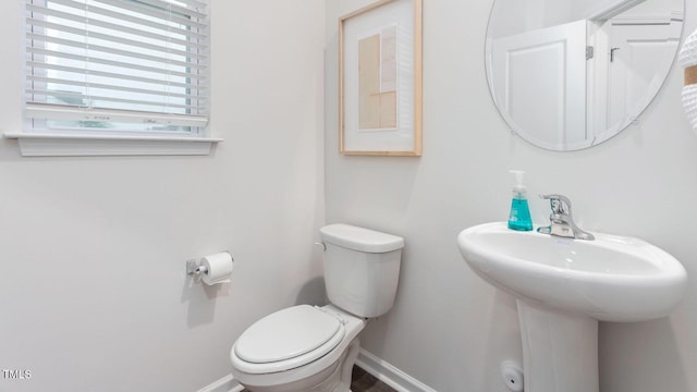 1911 Hinesley Dr, Durham, NC 27703 - bathroom featuring toilet and baseboards