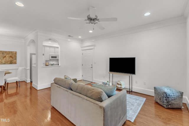 1310 Durlain Dr Unit 103, Raleigh, NC 27614 - living room featuring ceiling fan, ornamental molding, light wood finished floors, recessed lighting, and arched walkways