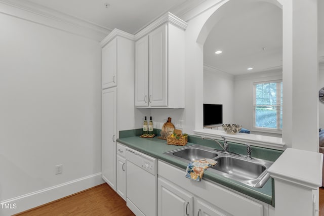 1310 Durlain Dr Unit 103, Raleigh, NC 27614 - kitchen with white dishwasher, arched walkways, light wood-style floors, white cabinets, and crown molding