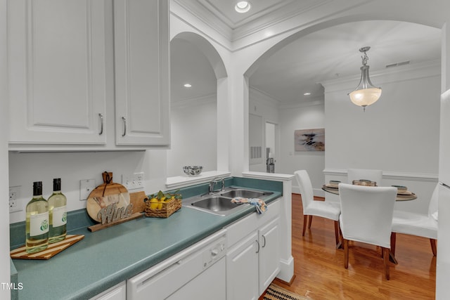 1310 Durlain Dr Unit 103, Raleigh, NC 27614 - kitchen featuring white dishwasher, crown molding, white cabinetry, arched walkways, and decorative light fixtures