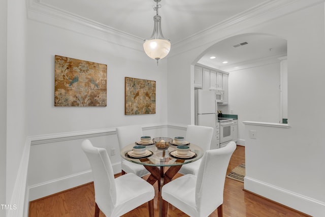 1310 Durlain Dr Unit 103, Raleigh, NC 27614 - dining space featuring arched walkways, wood finished floors, ornamental molding, and recessed lighting