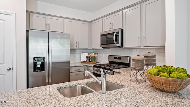 429 Belgian Red Way, Wake Forest, NC 27587 - kitchen with appliances with stainless steel finishes, gray cabinets, light stone countertops, and decorative backsplash