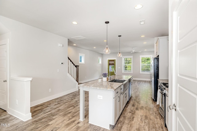 442 Granite Mill Blvd, Chapel Hill, NC 27516 - kitchen featuring appliances with stainless steel finishes, light wood-style floors, recessed lighting, a breakfast bar, and white cabinets