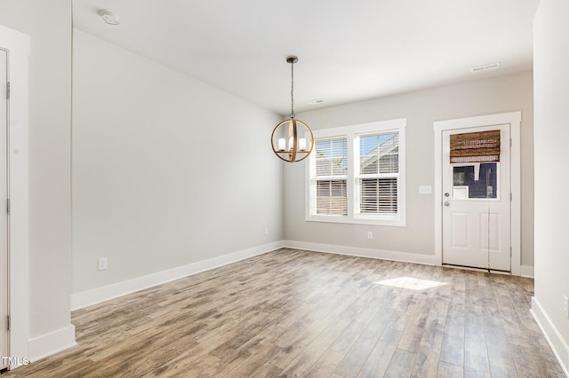 442 Granite Mill Blvd, Chapel Hill, NC 27516 - unfurnished dining area featuring a chandelier and wood finished floors
