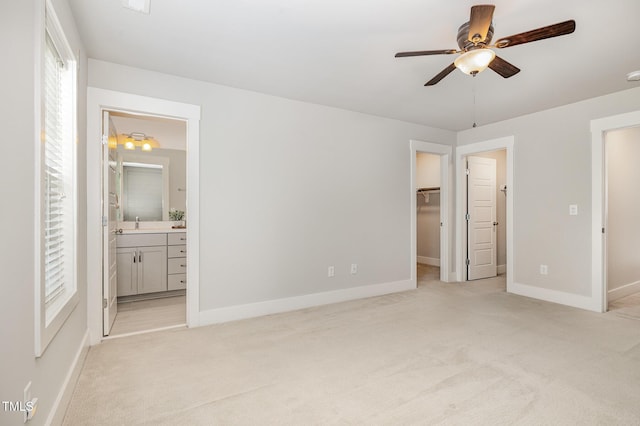 442 Granite Mill Blvd, Chapel Hill, NC 27516 - unfurnished bedroom featuring light carpet, a spacious closet, connected bathroom, a ceiling fan, and a closet