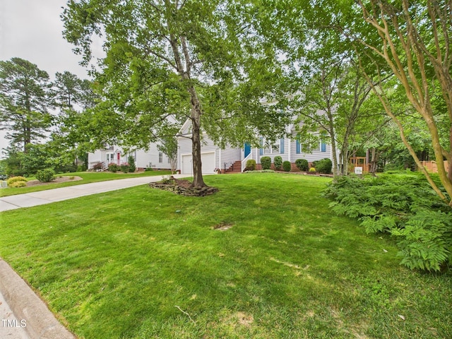 7501 Montibillo Pkwy, Durham, NC 27713 - obstructed view of property with a garage, driveway, and a front yard