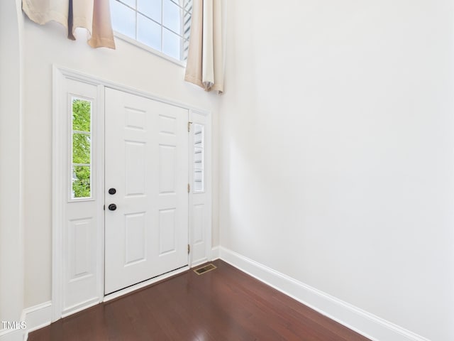 7501 Montibillo Pkwy, Durham, NC 27713 - foyer entrance with dark wood-type flooring and baseboards