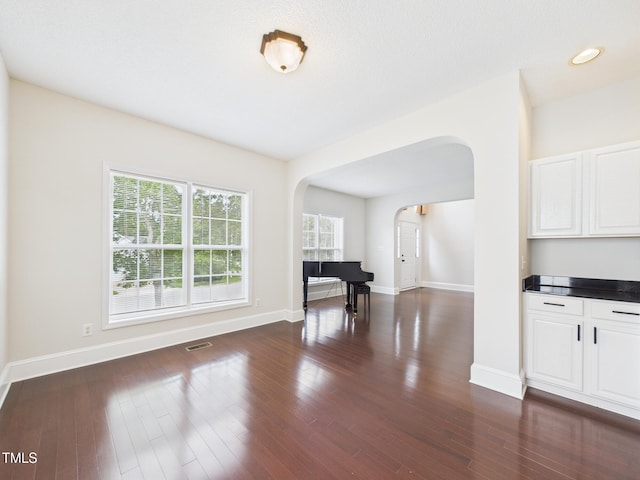 7501 Montibillo Pkwy, Durham, NC 27713 - dining room featuring arched walkways and dark wood-style flooring