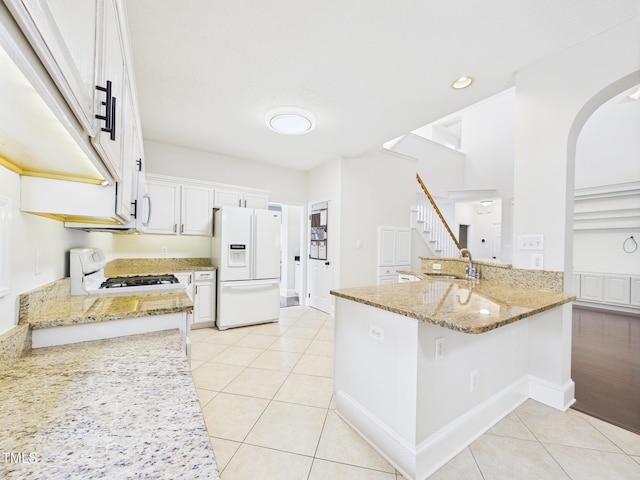 7501 Montibillo Pkwy, Durham, NC 27713 - kitchen with white appliances, light tile patterned flooring, light stone countertops, and recessed lighting