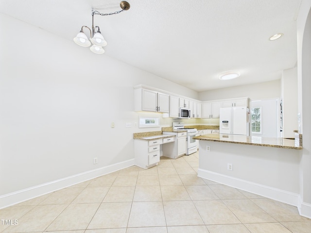 7501 Montibillo Pkwy, Durham, NC 27713 - kitchen with white appliances, a peninsula, light stone counters, light tile patterned floors, and white cabinetry