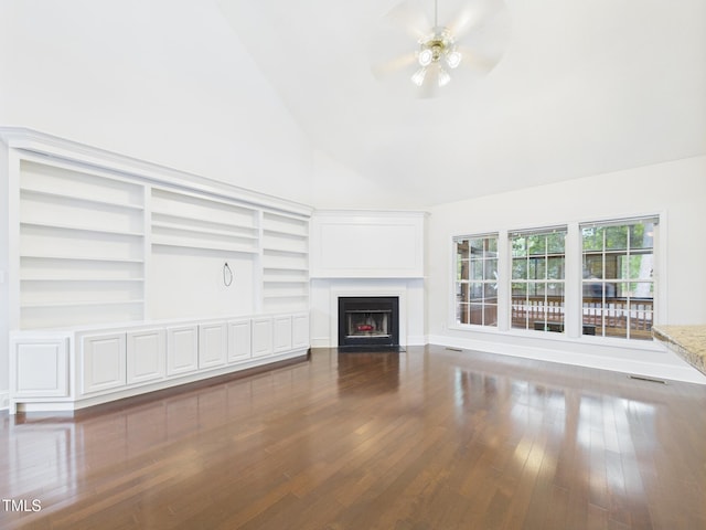 7501 Montibillo Pkwy, Durham, NC 27713 - unfurnished living room with a ceiling fan, high vaulted ceiling, a fireplace with flush hearth, wood finished floors, and built in features