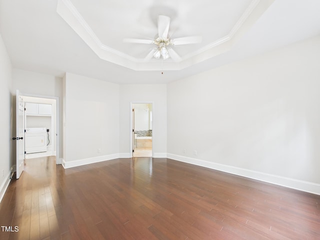 7501 Montibillo Pkwy, Durham, NC 27713 - unfurnished room with a tray ceiling, ceiling fan, dark wood-type flooring, crown molding, and washer / clothes dryer