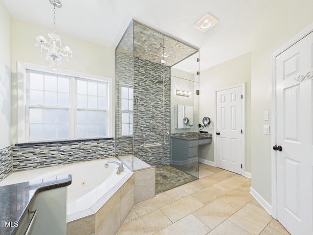 7501 Montibillo Pkwy, Durham, NC 27713 - bathroom featuring a jetted tub, vanity, tiled shower, a chandelier, and tile patterned flooring
