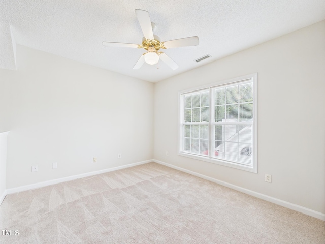 7501 Montibillo Pkwy, Durham, NC 27713 - unfurnished room with light carpet, ceiling fan, and a textured ceiling