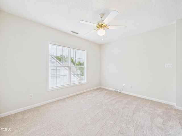 7501 Montibillo Pkwy, Durham, NC 27713 - spare room featuring light carpet, a ceiling fan, and a textured ceiling