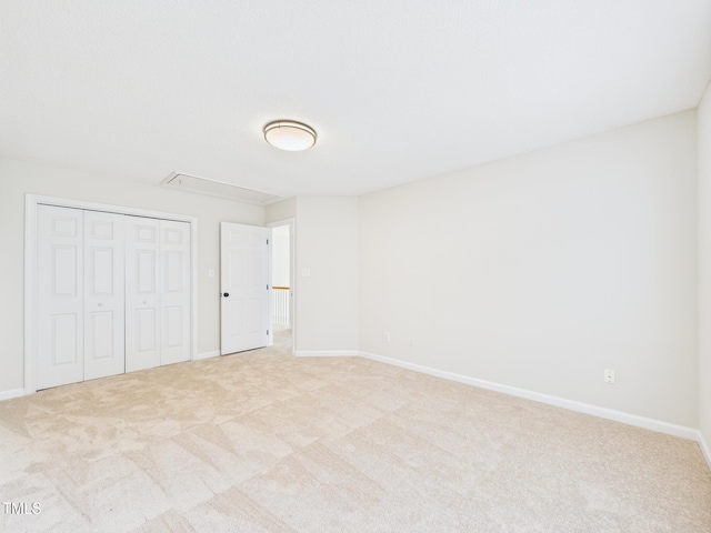 7501 Montibillo Pkwy, Durham, NC 27713 - unfurnished bedroom featuring attic access, light carpet, and a closet