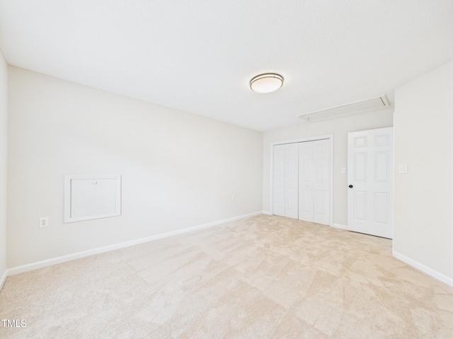 7501 Montibillo Pkwy, Durham, NC 27713 - unfurnished bedroom with attic access, carpet, and a closet