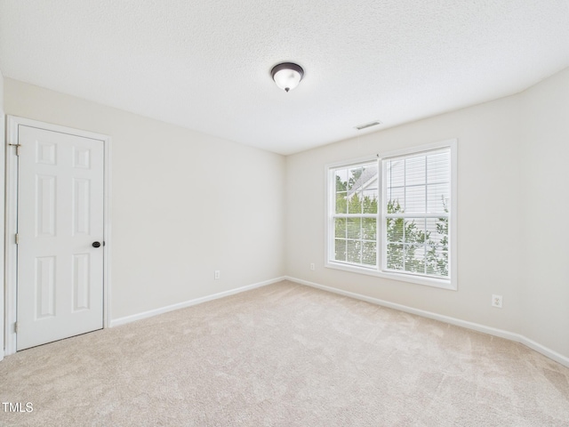7501 Montibillo Pkwy, Durham, NC 27713 - spare room with carpet floors and a textured ceiling