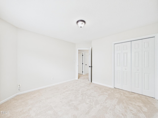 7501 Montibillo Pkwy, Durham, NC 27713 - unfurnished bedroom with light carpet and a closet