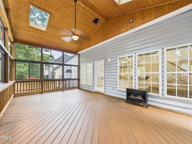 7501 Montibillo Pkwy, Durham, NC 27713 - unfurnished sunroom with a skylight and a wood stove