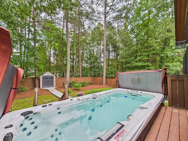 7501 Montibillo Pkwy, Durham, NC 27713 - view of swimming pool with a covered hot tub, a storage unit, a fenced backyard, and a wooden deck