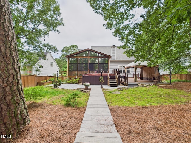7501 Montibillo Pkwy, Durham, NC 27713 - rear view of house featuring a fenced backyard, a gazebo, and a wooden deck