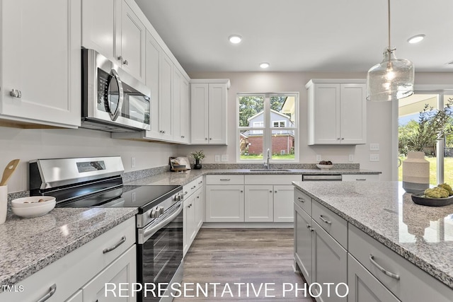 7678 New Sandy Hill Church Rd, Sims, NC 27880 - kitchen featuring stainless steel appliances, white cabinetry, light wood-type flooring, recessed lighting, and decorative light fixtures