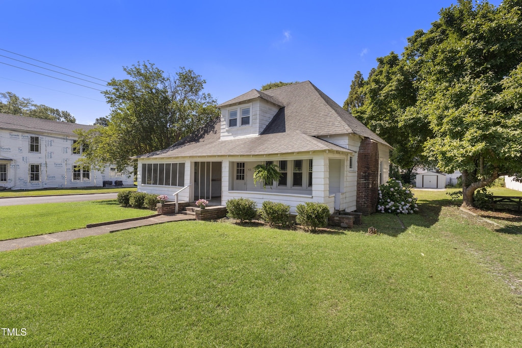 413 E Center St, Nashville, NC 27856 - bungalow-style house featuring a front lawn and roof with shingles