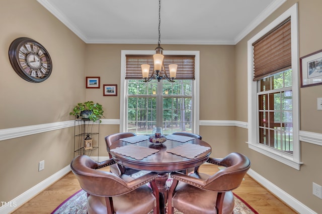3728 Marwick Ct, Wendell, NC 27591 - dining room featuring a chandelier, plenty of natural light, ornamental molding, and light wood-style floors