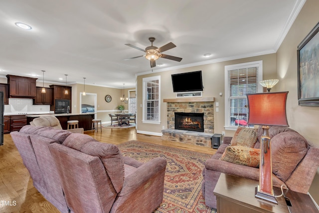 3728 Marwick Ct, Wendell, NC 27591 - living room with ornamental molding, a ceiling fan, light wood-style flooring, a stone fireplace, and recessed lighting