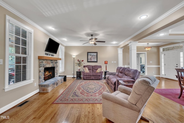 3728 Marwick Ct, Wendell, NC 27591 - living area featuring ceiling fan, a stone fireplace, decorative columns, light wood-type flooring, and crown molding