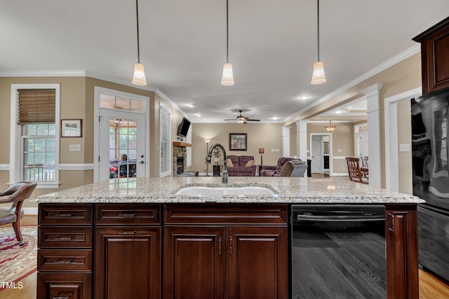3728 Marwick Ct, Wendell, NC 27591 - kitchen with black appliances, ceiling fan, a fireplace, open floor plan, and ornate columns