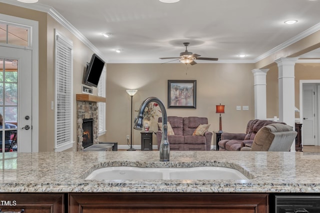 3728 Marwick Ct, Wendell, NC 27591 - kitchen featuring a ceiling fan, crown molding, light stone countertops, a stone fireplace, and open floor plan