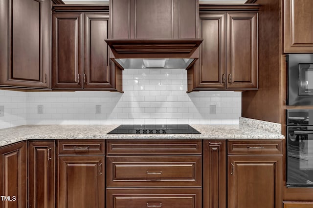 3728 Marwick Ct, Wendell, NC 27591 - kitchen with black appliances, dark brown cabinets, backsplash, and light stone counters