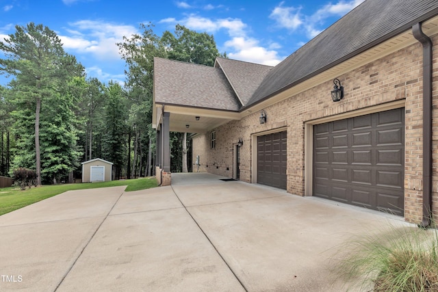3728 Marwick Ct, Wendell, NC 27591 - view of side of property featuring driveway, roof with shingles, brick siding, and a shed