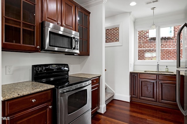400 W Rosemary St Unit 114, Chapel Hill, NC 27516 - kitchen with stainless steel appliances, dark wood-style flooring, crown molding, glass insert cabinets, and pendant lighting