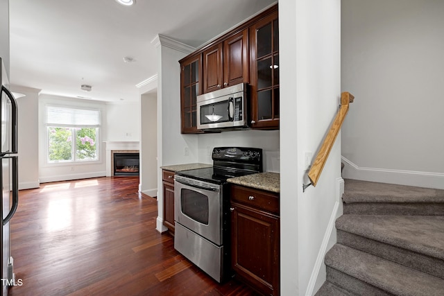 400 W Rosemary St Unit 114, Chapel Hill, NC 27516 - kitchen with stainless steel appliances, open floor plan, dark brown cabinetry, glass insert cabinets, and dark wood-style floors